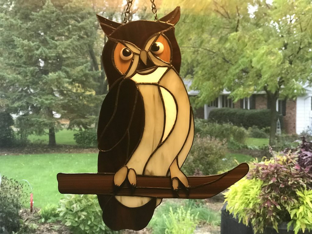 Owl on stained glass limb