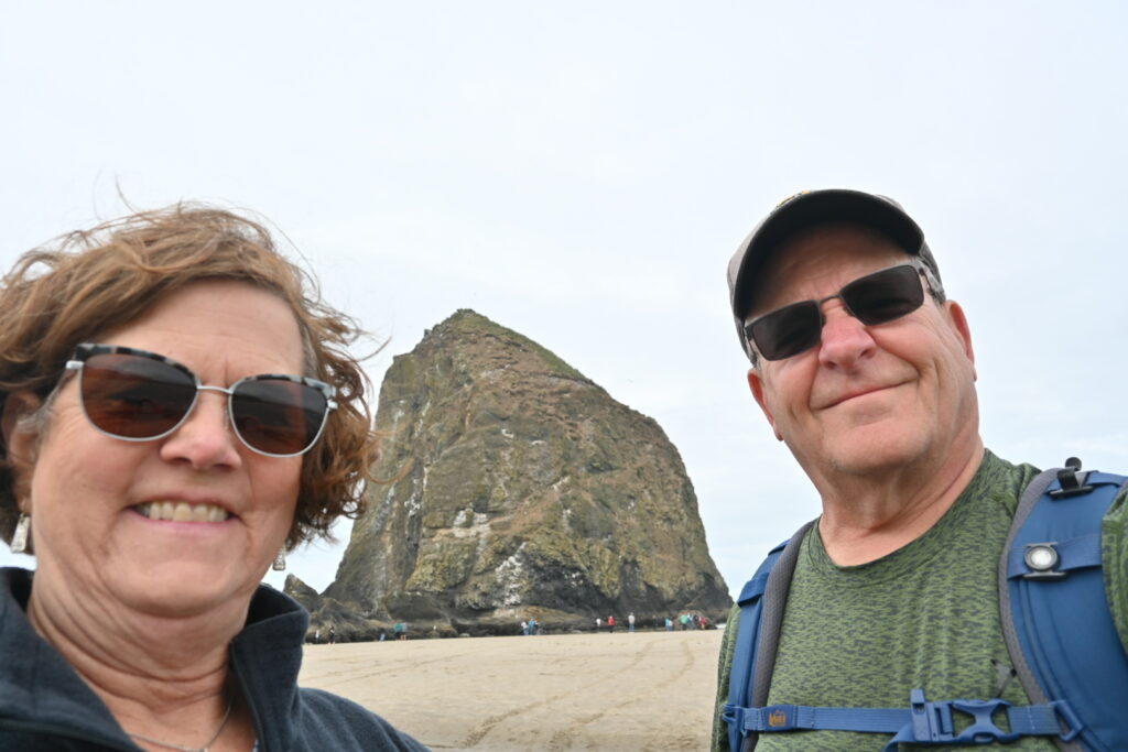 Two people and Haystack Rock